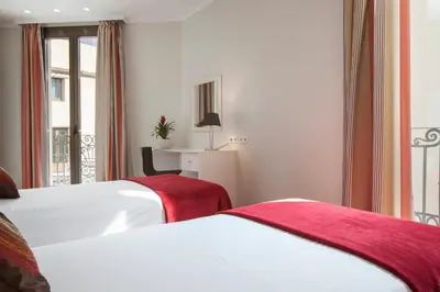 a hotel room with two beds and a desk at BCNGOTIC 31 in Barcelona