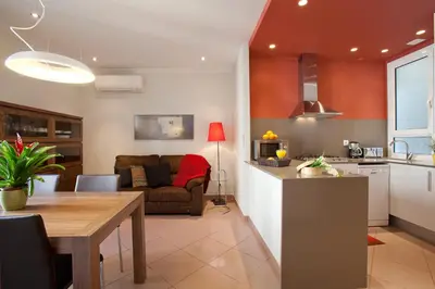 a kitchen and living room with a table and a couch at BCNGOTIC 33 in Barcelona