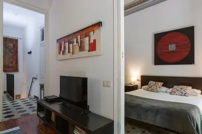 a bedroom with a bed and a television in it at AB Casanova Apartment in Barcelona