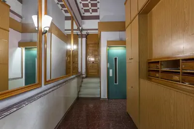a hallway with a green door in a building at AB Casanova Apartment in Barcelona