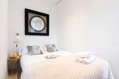 a bedroom with a bed and a mirror on the wall at AB Rossello Center Terrace in Barcelona