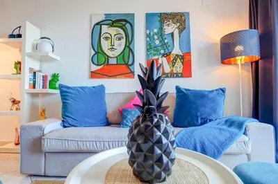 a living room with a couch and a pineapple on a table at Palma Fiesta Apartment by Hello Homes Sitges in Sant Pere de Ribes