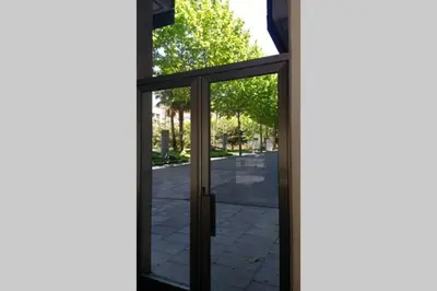 a glass door with a view of a street at Sea views & city skyline in Barcelona