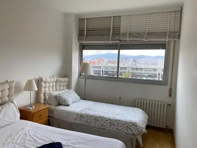 a bedroom with two beds and a window at Sea views & city skyline in Barcelona
