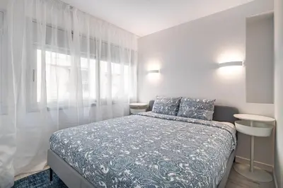 a bedroom with a bed and a window at Comtal homey apartments in Barcelona