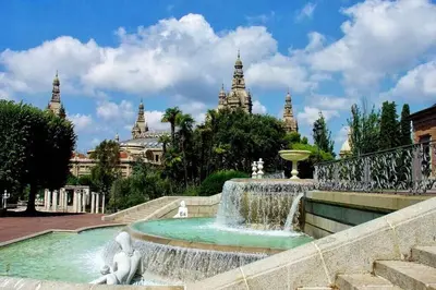 a fountain with a statue in front of a building at 2 BEDROOM APARTMENT SANTS in Barcelona