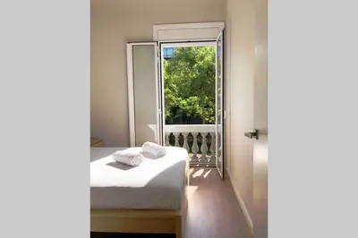 a bedroom with a bed and a window at 2 BEDROOM APARTMENT SANTS in Barcelona