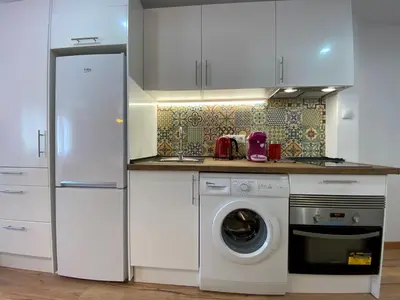 a kitchen with a refrigerator and a washing machine at Besos Beach Gem II By MyRentalHost in Sant Adria de Besos