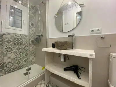 a bathroom with a sink and a shower with a mirror at Besos Beach Gem II By MyRentalHost in Sant Adria de Besos