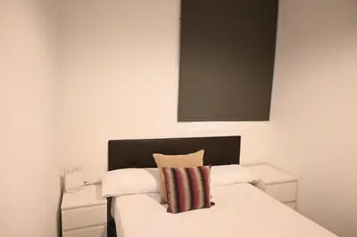 a bedroom with a bed with a black headboard at Homenfun Barcelona Les Corts in Barcelona