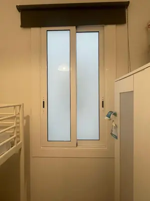 a door with three windows in a room at Homenfun Barcelona Les Corts in Barcelona