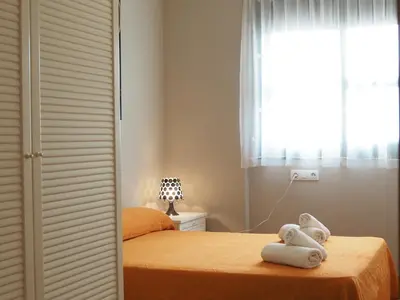 a bedroom with a bed with towels on it at NINFA Apartamento con balcón ideal familias con vistas al mar in Pineda de Mar
