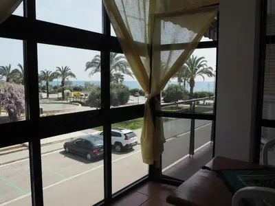 a room with a window with a car parked on a street at NINFA Apartamento con balcón ideal familias con vistas al mar in Pineda de Mar