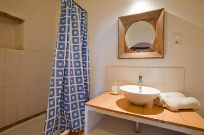a bathroom with a sink and a mirror at Cal Pau Cruset in Torrellas de Foix