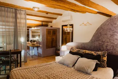 a bedroom with a large bed in a room at Cal Pau Cruset in Torrellas de Foix