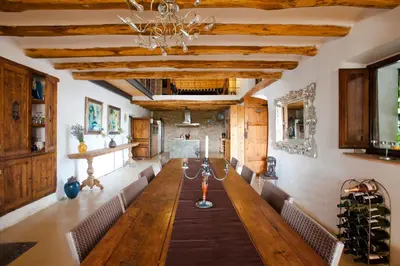 a dining room with a long table and chairs at Cal Pau Cruset in Torrellas de Foix