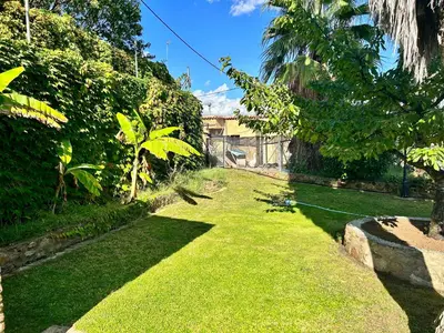 a yard with green grass and palm trees at Masia Pau Prat in Lliçà d'Amunt