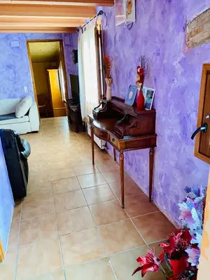 a room with a table and a purple wall at Masia Pau Prat in Lliçà d'Amunt