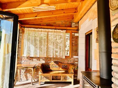 a porch with a bench and a window at Masia Pau Prat in Lliçà d'Amunt
