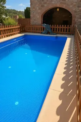 a blue swimming pool with a dolphin statue in a tunnel at Masia Pau Prat in Lliçà d'Amunt