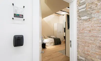 a door leading into a room with a bedroom at Barcelona Touch Apartments - Campalans in Hospitalet de Llobregat