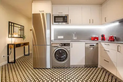 a kitchen with a refrigerator and a washing machine at Barcelona Touch Apartments - Campalans in Hospitalet de Llobregat