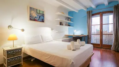 a bedroom with a white bed and a window at Bed&BCN Gracia III in Barcelona