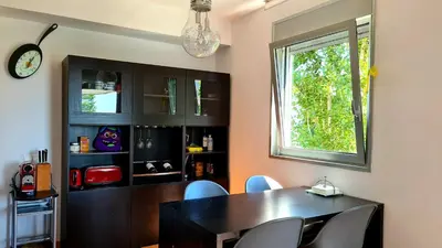 a dining room with a table and chairs and a window at Forum-CCIB-Relax Flats in Sant Adria de Besos