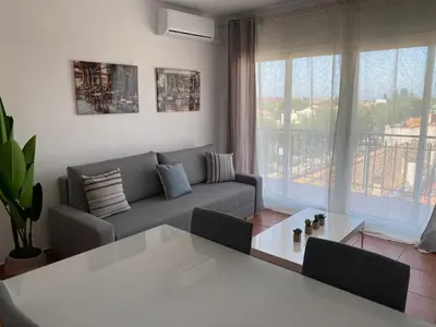 a living room with a couch and a table at Vilamarlux V in Vilassar de Mar