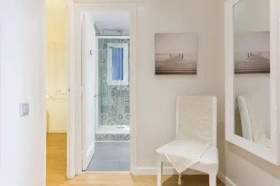 a white room with a chair and a mirror at Stay U-nique Apartments Mallorca in Barcelona