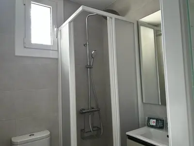 a bathroom with a shower and a toilet and a sink at Apartment Sagrada Familia Grassot - Industria by Interhome in Barcelona