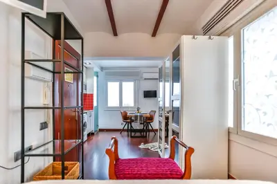 a living room with a red bench and a table at Ghat Apartments Montroig in Sitges