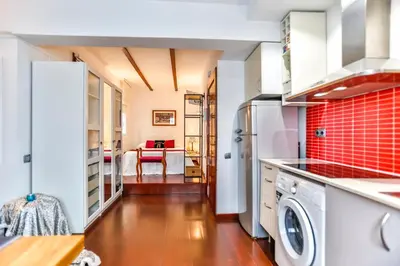 a kitchen with a washer and dryer at Ghat Apartments Montroig in Sitges