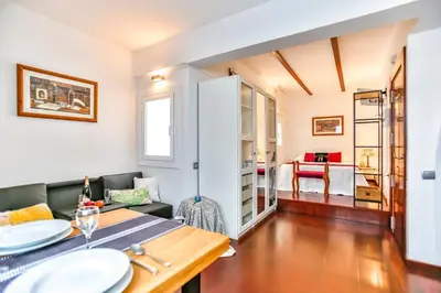 a living room with a table and a couch at Ghat Apartments Montroig in Sitges