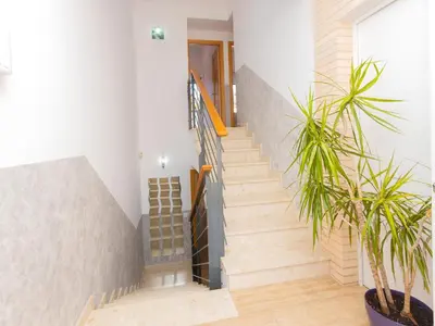 a staircase in a house with a potted plant at Holiday Home Nova by Interhome in Segur de Calafell