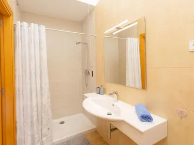 a white bathroom with a sink and a shower at Holiday Home Nova by Interhome in Segur de Calafell