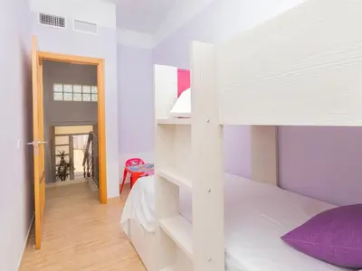 a bedroom with a bunk bed with a ladder at Holiday Home Nova by Interhome in Segur de Calafell
