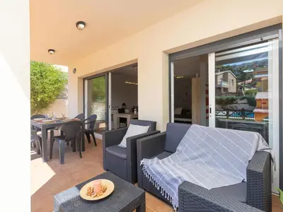 a living room with a couch and chairs and a table at Holiday Home Nova by Interhome in Segur de Calafell