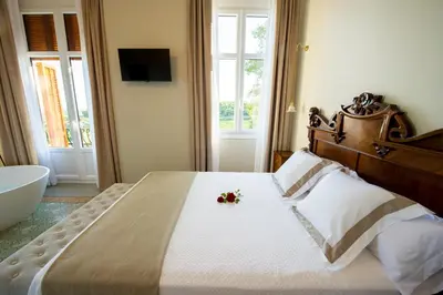 a bedroom with a large bed with flowers on it at Bolet Casa Modernista in Castellví de la Marca
