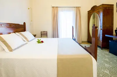 a bedroom with a large white bed with a flower on it at Bolet Casa Modernista in Castellví de la Marca