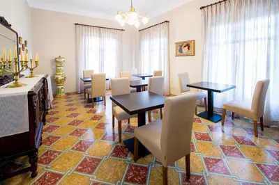 a dining room with tables and chairs and a chandelier at Bolet Casa Modernista in Castellví de la Marca