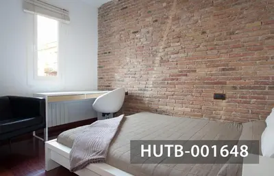a bedroom with a brick wall and a bed at Ghat Apartment Poble Sec Barcelona in Barcelona