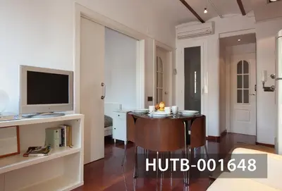 a living room with a table and a television at Ghat Apartment Poble Sec Barcelona in Barcelona