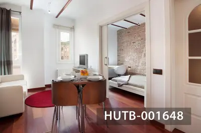 a living room with a table in the middle of a room at Ghat Apartment Poble Sec Barcelona in Barcelona