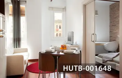 a living room with a small table and a television at Ghat Apartment Poble Sec Barcelona in Barcelona