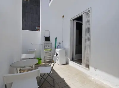 a white room with a table and chairs and a window at La Platgeta · La Platgeta · Ideal family apartment, with private terrace in Vilassar de Mar