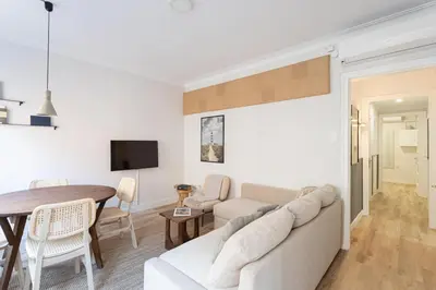 a living room with a couch and a table at Stylish 3 Bedroom Apartment in Barcelona