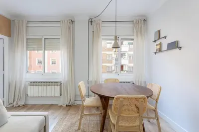 a dining room with a table and chairs at Stylish 3 Bedroom Apartment in Barcelona