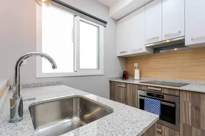 a kitchen with a stainless steel sink and a window at 3 Bdr&terrace Close To Subway in Hospitalet de Llobregat