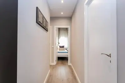 a hallway with a room with a bed and a window at 3 Bdr&terrace Close To Subway in Hospitalet de Llobregat